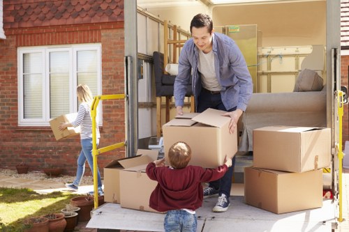 Packed boxes and furniture prepared for a house move in Swiss Cottage