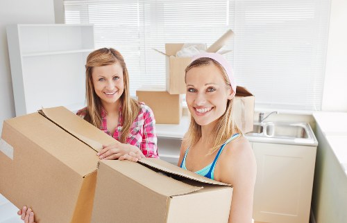 Local movers unpacking boxes in a Swiss Cottage apartment