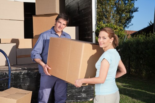 Moving crew carrying furniture from a flat in Swiss Cottage
